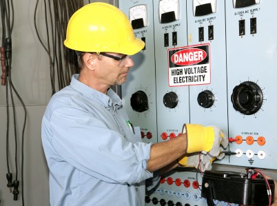 Elite Electrical Services industrial electrician working with high voltage.